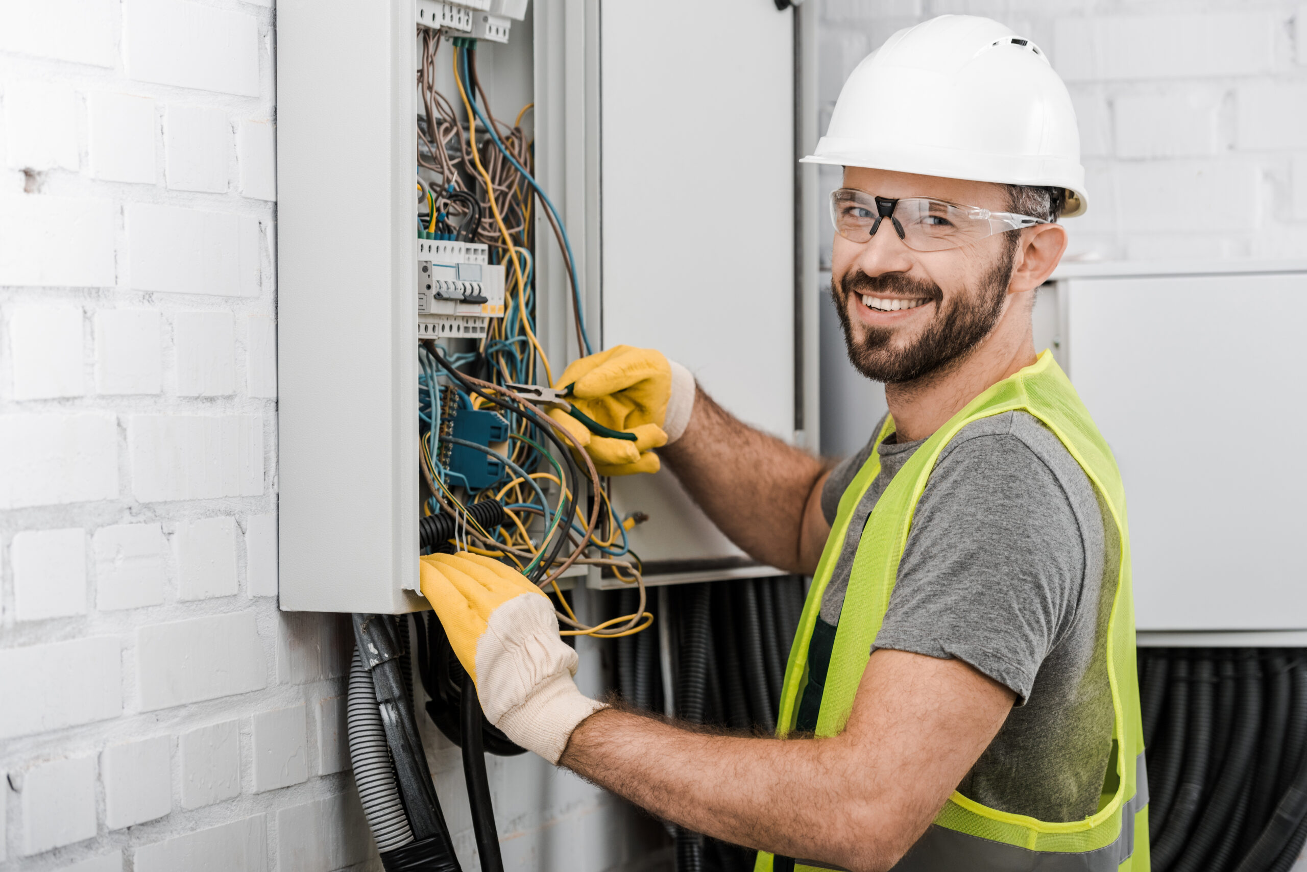 Professional electrician working on electrical panel
